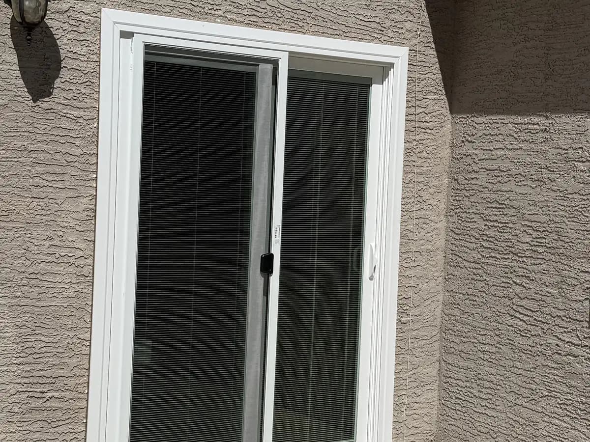Sliding patio door with screen seen from the patio side.